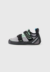 Light gray and black climbing shoe with mint green accents, two black Velcro straps labeled "REFLEX VS," and white "SCARPA" branding.