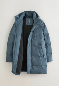 Puffy Thermojacke in dunklem Teal, ausgestattet mit Kapuze, Frontreißverschluss, Druckknöpfen und zwei Seitentaschen. Gefüttert mit schwarzem Fleece-Innenfutter.