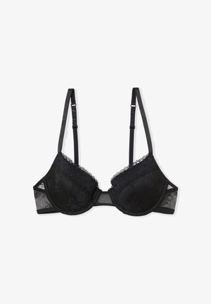 Soutien-gorge en dentelle noire avec bonnets rembourrés, bordure festonnée et bretelles réglables. Côtés en maille avec accents à pois. Design classique avec armatures pour un maintien optimal.