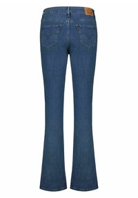 Jeans flare in denim blu con vita media, dotati di due tasche posteriori, cuciture sottili e un'etichetta in pelle sul girovita.