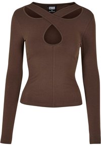 Brown long-sleeve top with a fitted design, featuring a cutout neckline and crossing shoulder details. Made from soft material.