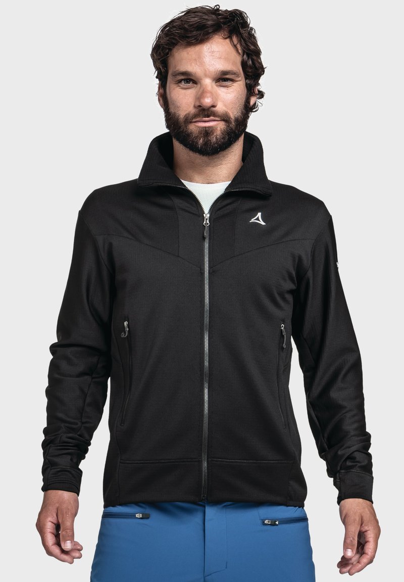 Schwarze Zip-Jacke mit hohem Kragen, ausgestattet mit seitlichen Reißverschlusstaschen und einem Logo auf der linken Brust. Glattes Material mit strukturierter Oberfläche.