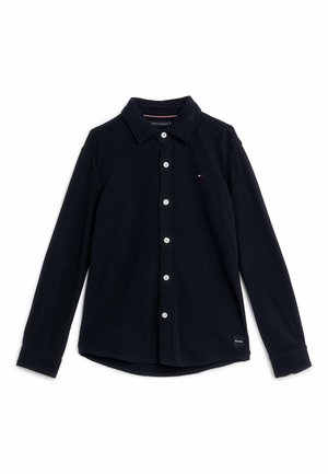 Long-sleeve navy blue button-up shirt with collar, small embroidered logo on chest, and label near hem, displayed on white background.