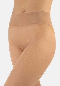 Slip beige senza cuciture con una texture liscia e morbida. Presenta un ampio elastico in vita per il massimo comfort, progettato per aderire strettamente al corpo.