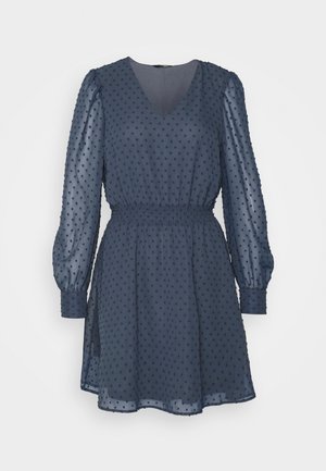 Marineblaues, transparentes Kleid mit strukturierten Polka-Dots, langen Puffärmeln, V-Ausschnitt, elastischer Taille und eingefassten Handgelenken.