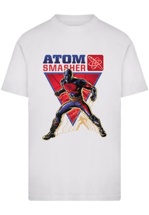 White t-shirt featuring a graphic of a male superhero called Atom Smasher in black and red costume, with bold text above and a triangular design.