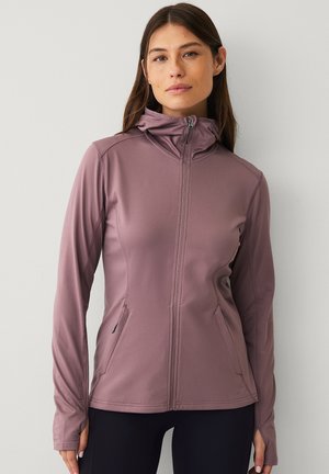 Aansluitende, ritssluitingjack in gedempt mauve, gemaakt van soepel, rekbaar materiaal. Heeft lange mouwen, een hoge kraag en zijzakken.