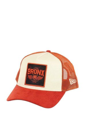 Baseball cap with a cream front, orange bill, and mesh sides. Features a "BRONX" patch with wings and embroidered details.