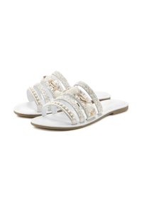 White sandals with three wide straps, adorned with shells and beads, featuring a flat sole and a smooth leather-like texture.