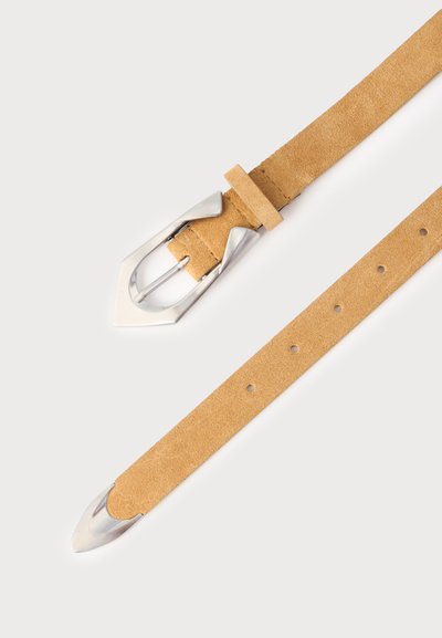 Ceinture en daim beige avec boucle pointue argentée et embout métallique sur fond blanc uni.