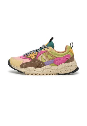 Chunky multicolor sneaker with beige sole, pink, brown, green, purple, and yellow panels, grey laces, and black pull tabs on tongue and heel.