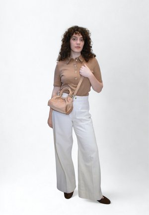 Light brown polo shirt with buttons, paired with high-waisted white wide-leg trousers. Carrying a small beige handbag with a gathered design.
