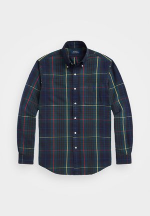 Langärmliges Karoshemd mit dunkelblauen, grünen, roten und gelben Karomustern, Button-Down-Kragen und Brusttasche. Aus Baumwolle.