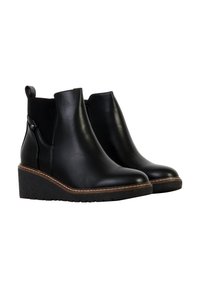 Bottes courtes en cuir noir avec semelles compensées, dotées d'une finition lisse, de fermetures éclair latérales et de coutures contrastées marron le long du bord.