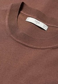Pull marron tricoté à col rond avec une étiquette blanche MNG Man indiquant la taille M pour EUR-USA et MEX.