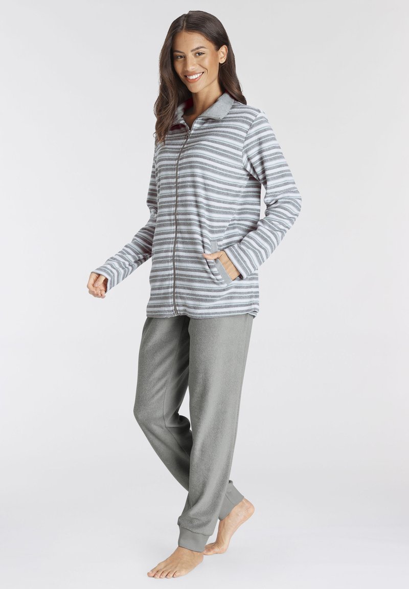 Gray and white striped zip-up jacket with a collar, paired with soft, gray fleece pants. Both feature comfortable, relaxed fits.