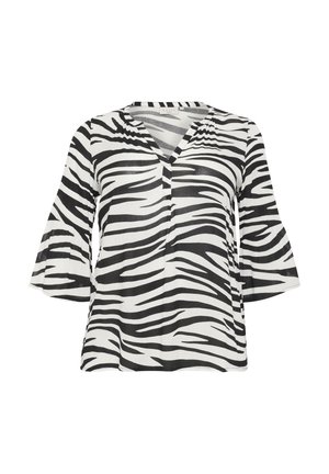 Mustvalge zebra mustriga pluus V-kaeluse, kellukese varrukate ja kerge tekstureeritud kangaga. Omab lõõgastavat istuvust koos nähtavate õmbluse detailidega.