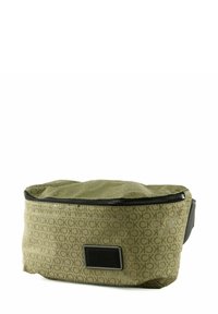 Sac en tissu vert avec une finition brillante, motif en relief du logo CK, fermeture éclair noire et étiquette en cuir noir avec l'inscription "Calvin Klein".