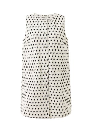 Débardeur blanc sans manches avec motif de points noirs irréguliers, boutons sur le devant, et deux poches horizontales fendues.