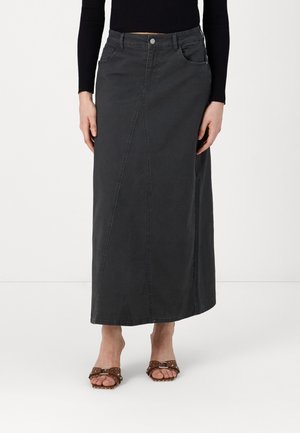 Long grey denim skirt with a straight cut, featuring a front seam detail and pockets, paired with brown studded slide sandals.
