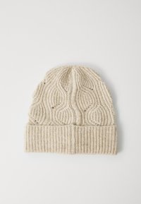 Beige gebreide wintermuts met omgeslagen geribbelde rand en golvende verticale kabelbreipatroon op een witte achtergrond.
