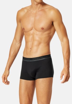 Schwarze Baumwoll-Boxershorts mit einem weichen elastischen Bund, der den Markennamen trägt. Das Design ist figurbetont und hat eine etwas längere Beinausschnittlänge.