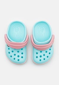 A pair of blue Crocs with pink straps, featuring multiple ventilation holes on the surface and a textured footbed for comfort.