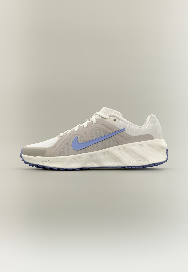 Λευκό και ανοιχτό γκρι αθλητικό παπούτσι με μπλε σήμα Nike, παχύ πέλμα με λογότυπο Comforday, εμφανίζεται σε ουδέτερο φόντο.