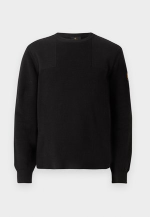 Maglione nero a maglia con texture a costine, scollatura a girocollo e maniche lunghe. Presenta un sottile design a pannelli e un piccolo logo sulla manica.