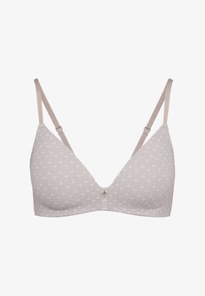 Světle béžová podprsenka s jemným vzorem vějíře a puntíků, nastavitelnými ramínky a malým dekoračním přívěskem uprostřed vpředu.