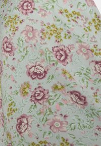 Tecido floral com um fundo verde menta claro, adornado com flores rosa e roxas, complementadas por folhagem verde e detalhes delicados.