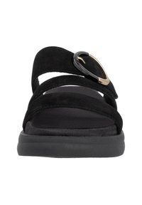 Black suede sandals featuring three straps, a thick sole, and a gold and black accent buckle detail. Flat and minimalistic design.