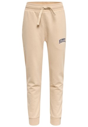 Beżowe spodnie dresowe z prążkowanymi ściągaczami przy nogawkach i pasie, regulowanym sznurkiem oraz małym czarnym logo "Hummel" na górnej części lewej uda.