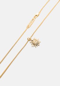 Delicado collar de cadena de oro con un colgante en forma de sol y una pequeña placa rectangular grabada con "NICON".