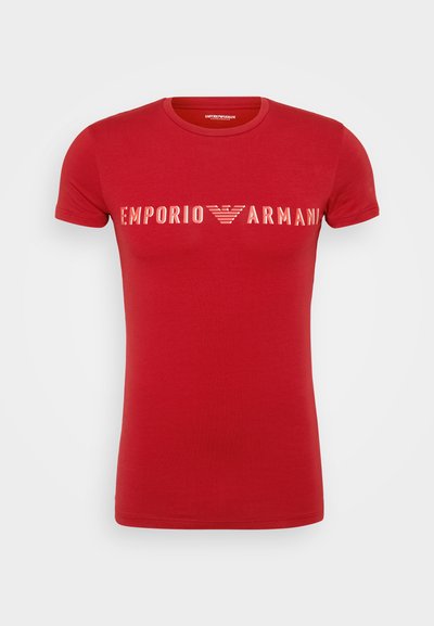 Red short-sleeve t-shirt made of cotton, featuring the "Emporio Armani" logo in white across the chest. Crew neck design.