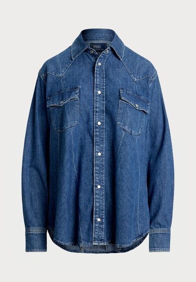 Dark blue denim shirt featuring a pointed collar, snap buttons, two chest pockets, and western-style yoke seams. Long sleeves with button cuffs.