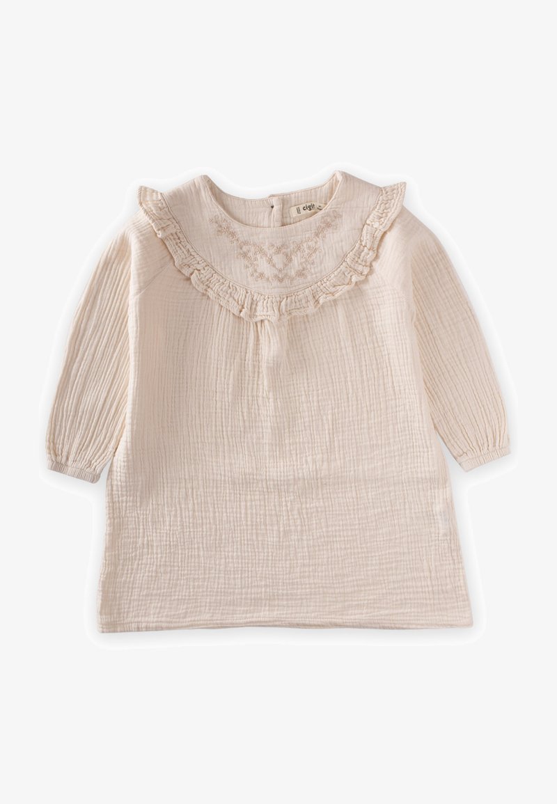 Svetlo bež obleka z dolgimi rokavi in9 ruffle ovratnikom ter teksturirano tkanino, ki ima na sprednji strani nežno vezenje.