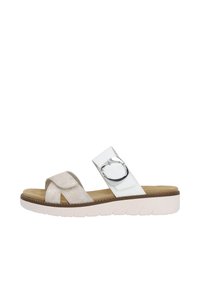 Lightweight slide sandal in beige and white, featuring a shiny silver circular accent, soft suede texture, and cushioned footbed with a ridged sole.