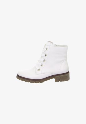 White leather ankle boot with lace-up front, metal eyelets, and thick brown rubber sole with treaded pattern.