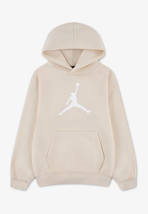 Beige hættetrøje med forreste kængurulomme og stort hvidt Jumpman-basketballlogo på brystet. Der er ingen personer til stede.