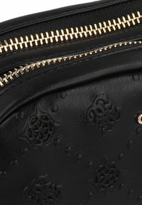 Borsa in pelle nera con motivi floreali in rilievo, dotata di chiusura lampo dorata e superficie testurizzata, accentuata da punti in rilievo e dettagli intricati.