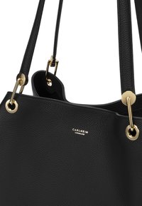 Black leather tote bag featuring a textured surface, gold hardware accents, and a visible logo. The bag has two shoulder straps.