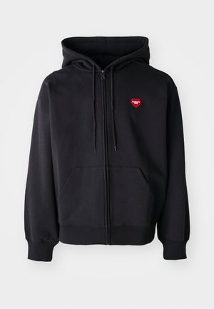 Black zip-up hoodie made of cotton blend, featuring a front pocket and a red heart logo on the left chest. Smooth texture, adjustable drawstring hood.