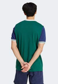 Green and navy short-sleeve polo shirt with white striped accents, featuring a relaxed fit and a smooth cotton texture.