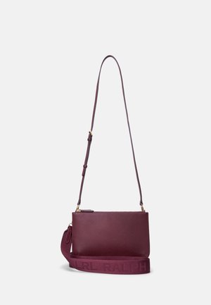 Purple leather crossbody bag with adjustable thin strap and wider fabric strap embossed with "RALPH" lettering.