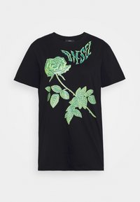 Camiseta negra de manga corta con un gráfico de rosa verde y diseño de texto. Material suave de algodón con un corte relajado y escote redondo.