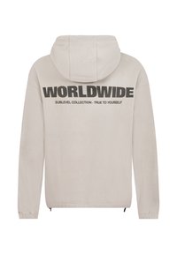 Light grey fleece hoodie featuring a hood, long sleeves, and a black graphic text design on the back. Zipper accents at the hem.