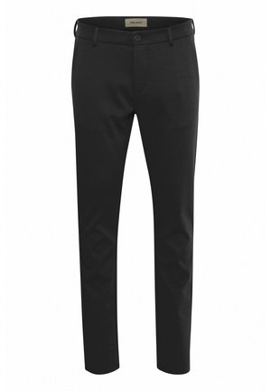 Pantalons noirs à coupe slim, fabriqués en tissu texturé, dotés d'une fermeture à bouton et de passants de ceinture. Surface lisse avec un design ajusté.