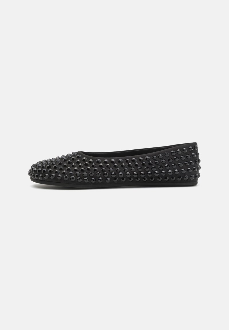 Black flat shoes with a rounded toe, made of suede, featuring a textured surface adorned with glossy black studs across the upper.