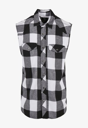 Juodai balta kostiuminė be rankovių marškiniai su užsegimu priekyje, dviem krūtinės kišenėmis ir kontrastingu apykakle bei rankovių kraštais.